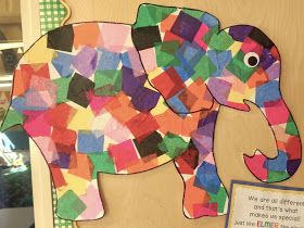 an elephant made out of colored paper on a bulletin board next to a sign that says we are different and not quite multi - colored