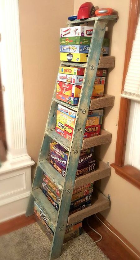 an old ladder is used as a bookshelf to hold children's books