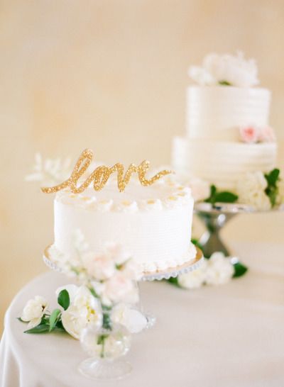 two white wedding cakes sitting on top of a table