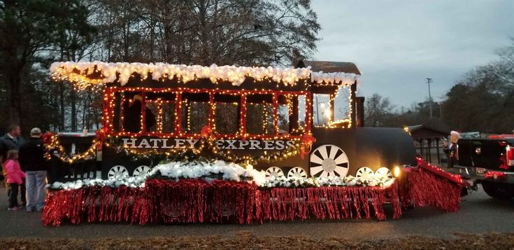 a train decorated with christmas lights and decorations