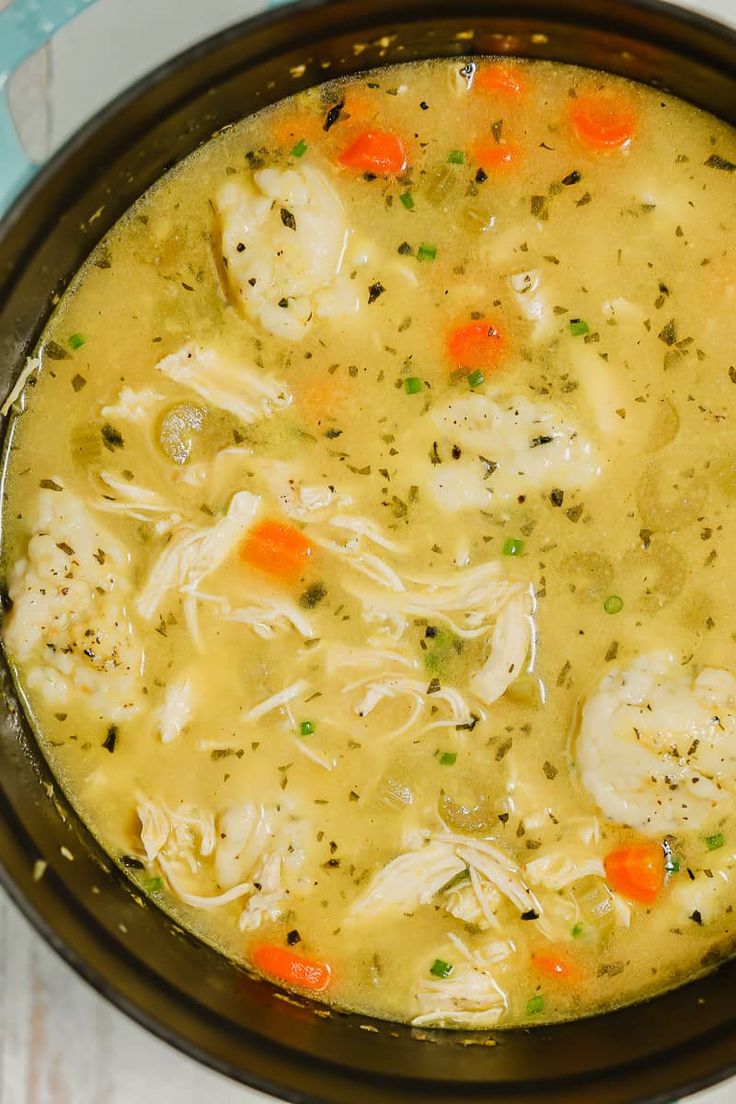 chicken and dumpling soup in a crock pot with text overlay that reads one pot chicken and dumpling soup