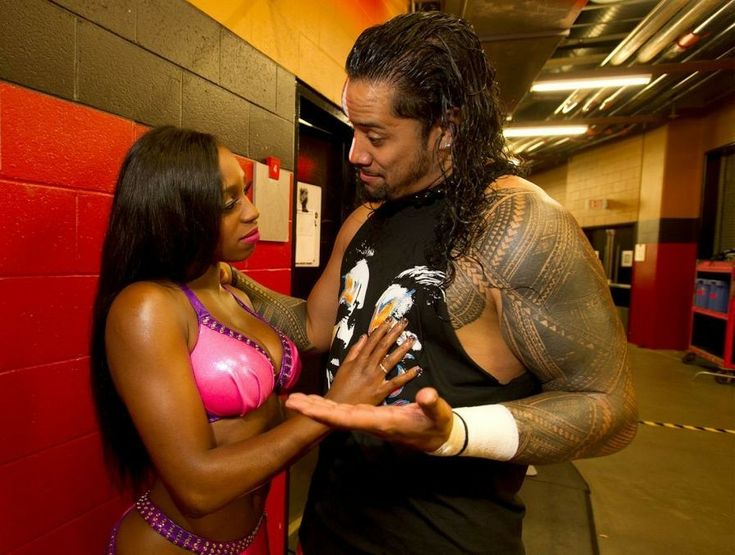 a man standing next to a woman in a wrestling ring