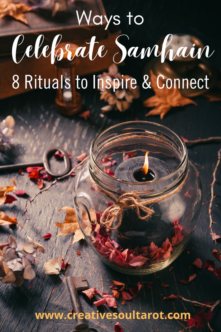 a glass jar filled with leaves and a candle