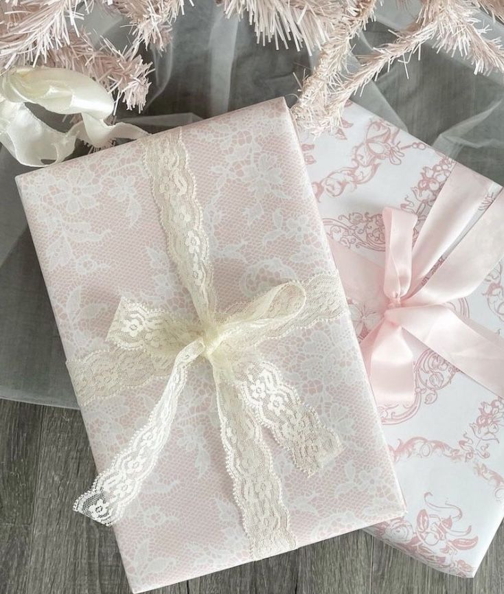 two pink and white wrapped presents on a table