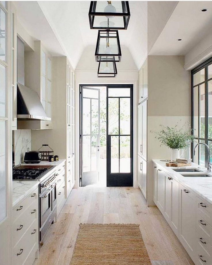 the instagram page on instagram shows an image of a kitchen with white cabinets and wood floors