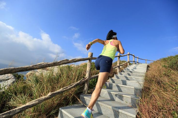 a woman is running down some stairs