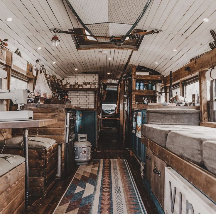 the inside of an rv that is full of furniture and decor, including mattresses