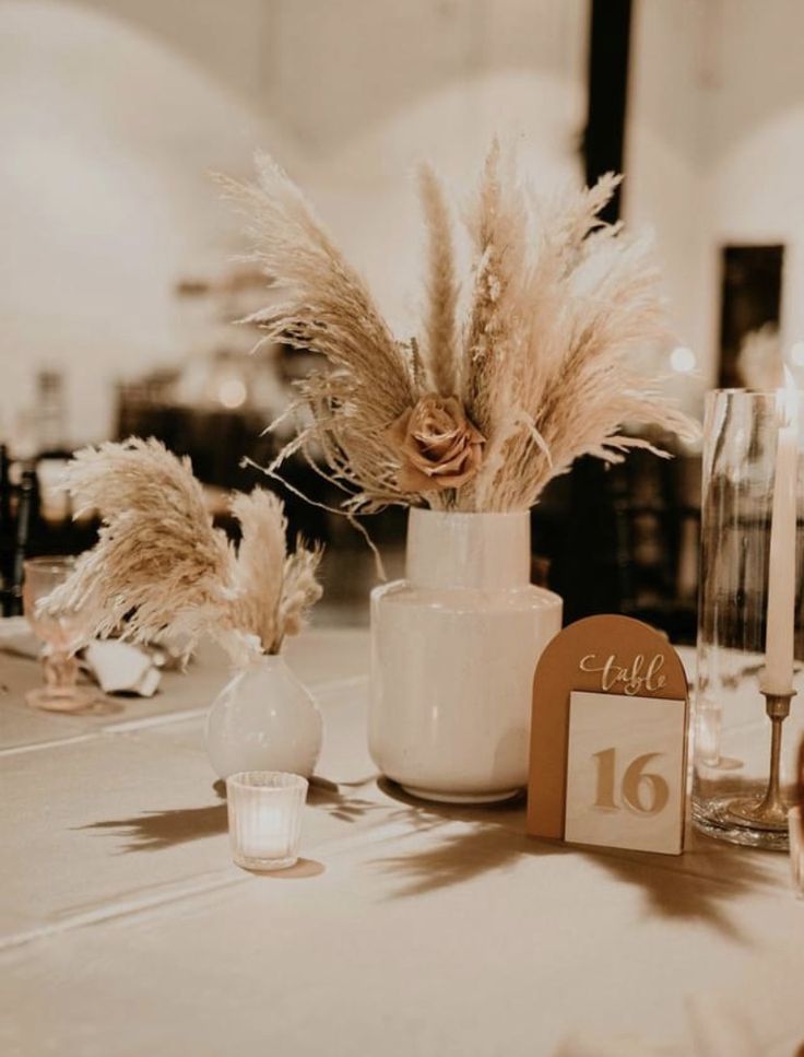 the table is set with flowers, candles and place cards for guests to sit at