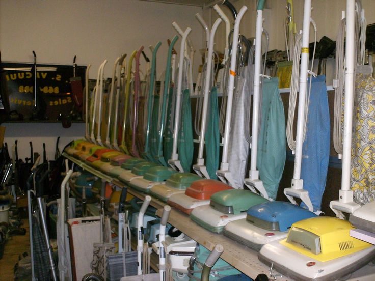 a room filled with lots of different types of surfboards on shelves next to each other