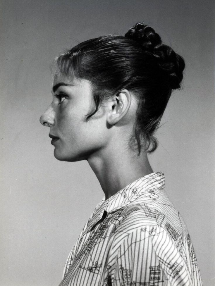 black and white photograph of a woman's profile with hair in a high bun