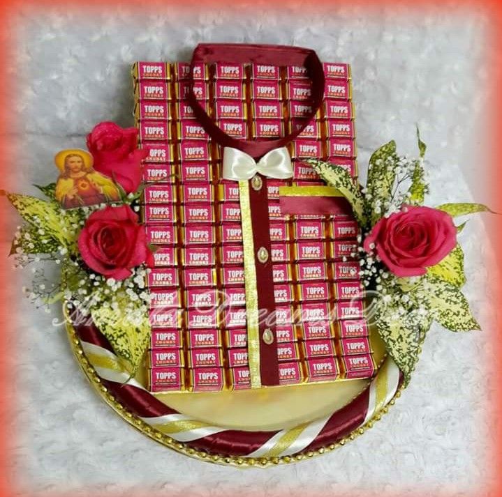 a red and gold gift box with roses on it