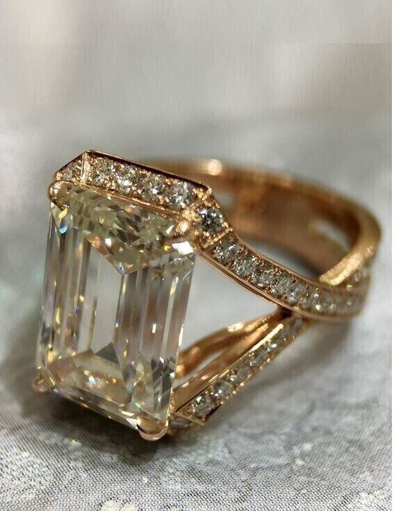 a fancy ring with an emerald cut diamond in the center