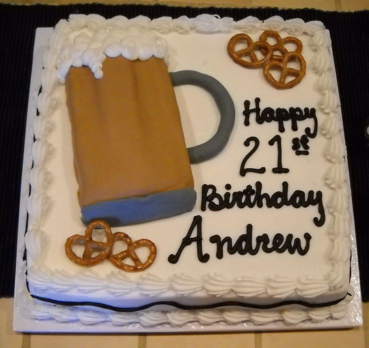 a birthday cake with a mug and pretzels on it