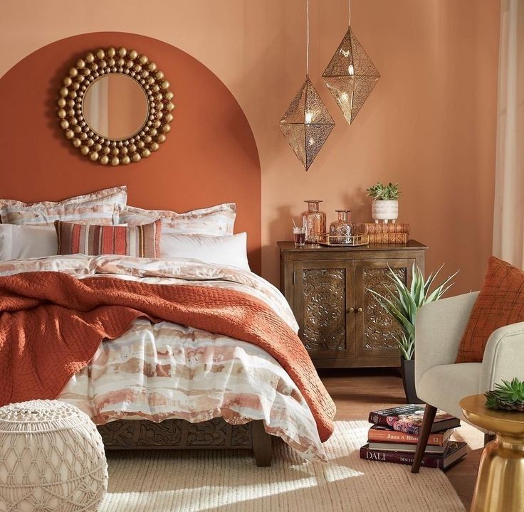 a bedroom with an orange wall and bed in the corner, pillows on the floor