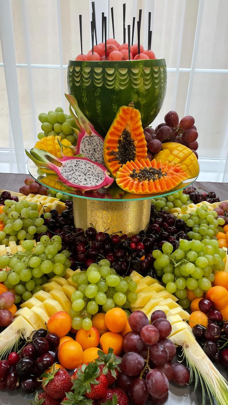 a table topped with lots of different types of fruits and veggies on top of each other