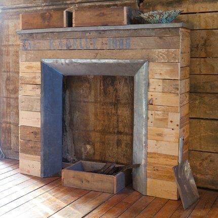 an old fireplace in a wooden room