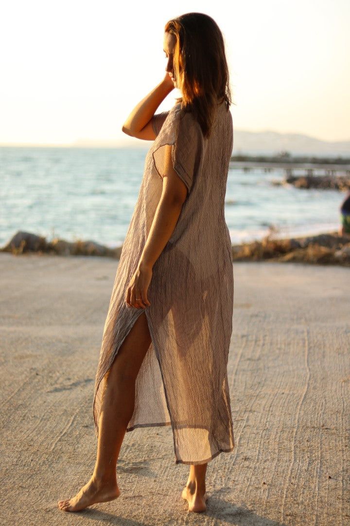 Airy, light and beautiful, Anatolico beach dresses are very comfortable yet stylish for warm beach days. Their fabric is loomed by our talented artisan partners in Mediterranean Turkey so delicately, that they have a silky feeling and look although they are made of 100% Turkish cotton. The dresses have the same straight cut as the kaftan dresses, with v shaped neck and a little drape in the front. They come in 2 sizes as S/M/L (36-38-40) and XL (42-44). Material: 100% Cotton Beige V-neck Linen Dress For Beach, Summer Linen V-neck Dress For The Beach, Beige Maxi Beach Dress, Beige Maxi Beach Dress For Beach Party, Breezy Flowy Tunic Beach Dress, Beachy Beige Maxi Dress For Beach Season, Flowy Breezy Tunic Beach Dress, Beachy Beige Maxi Beach Dress, Linen Maxi Dress For Beach Cover-up