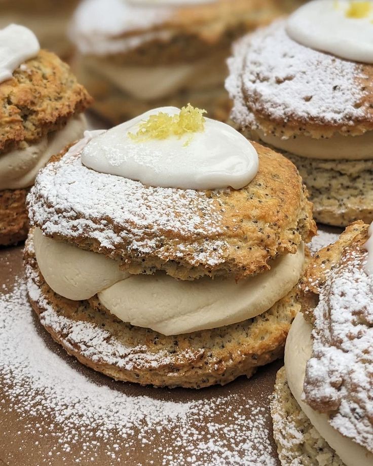 several pastries covered in powdered sugar and topped with icing