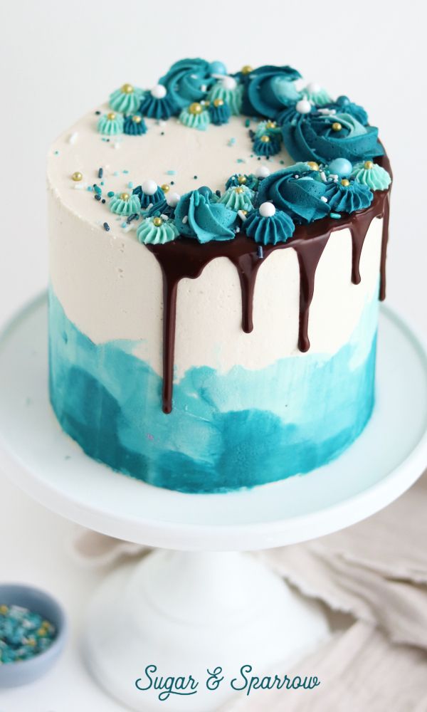 a blue and white cake sitting on top of a plate