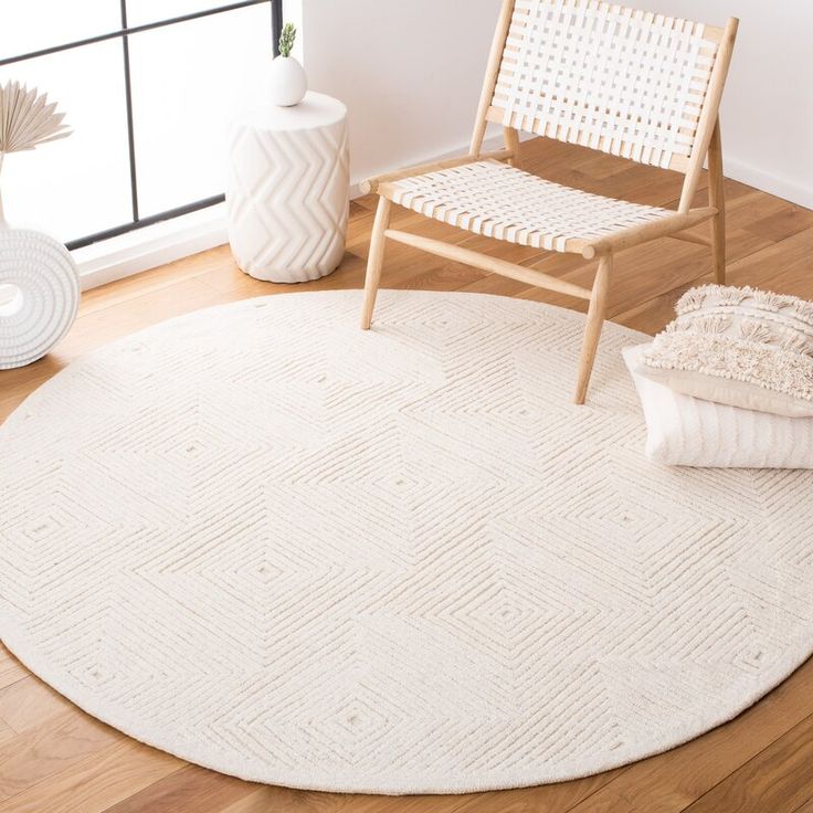 a white rug in the corner of a room with a chair and vases on the floor