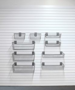 four metal baskets sitting on top of each other in front of a white garage door