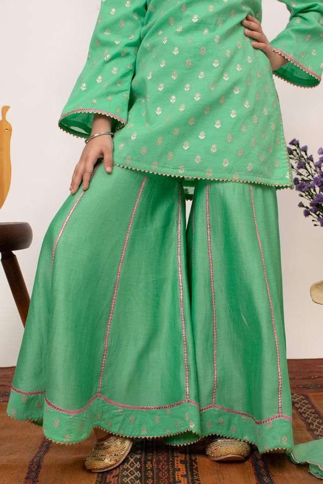 Green chanderi silk kurta with floral embroidered yoke and butti patterns. Comes with sharara.
Components: 2
Pattern: Embroidered
Type Of Work: Floral
Neckline: Round
Sleeve Type: Full
Fabric: Chanderi Silk, Lining: Cotton
Color: Green
Other Details: 
Attached lining
Note: Dupatta shown in the images is not for sale
Occasion: Festive and Wedding - Aza Fashions Semi-stitched Slub Silk Sets With Dori Work, Cotton Silk Palazzo Set With Dori Work For Festivals, Chanderi Sets With Gota Work For Eid, Festival Cotton Silk Palazzo Set With Dori Work, Festive Slub Silk Sets With Resham Embroidery, Festival Sets In Slub Silk With Resham Embroidery, Festival Sets With Resham Embroidery In Slub Silk, Eid Slub Silk Sets With Resham Embroidery, Cotton Silk Sets With Resham Embroidery For Navratri