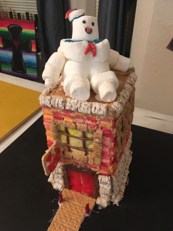 a white teddy bear sitting on top of a building made out of waffles