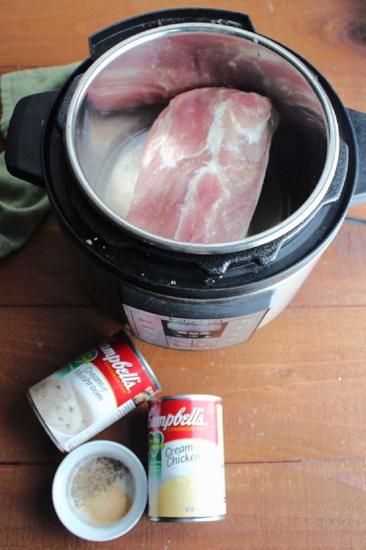 two raw meats in an instant pot with spices and seasoning next to it