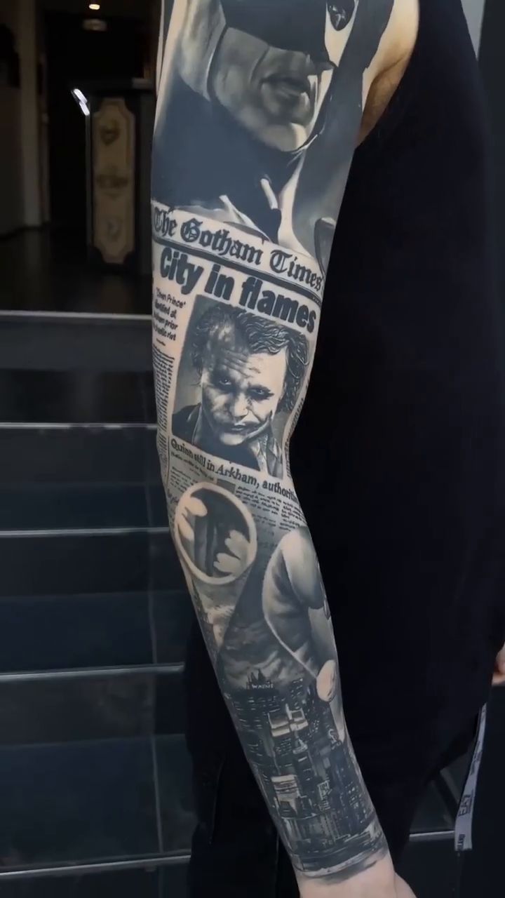 a man with a batman tattoo on his arm