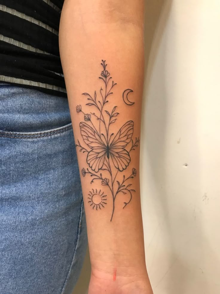 a woman's arm with a flower tattoo on it