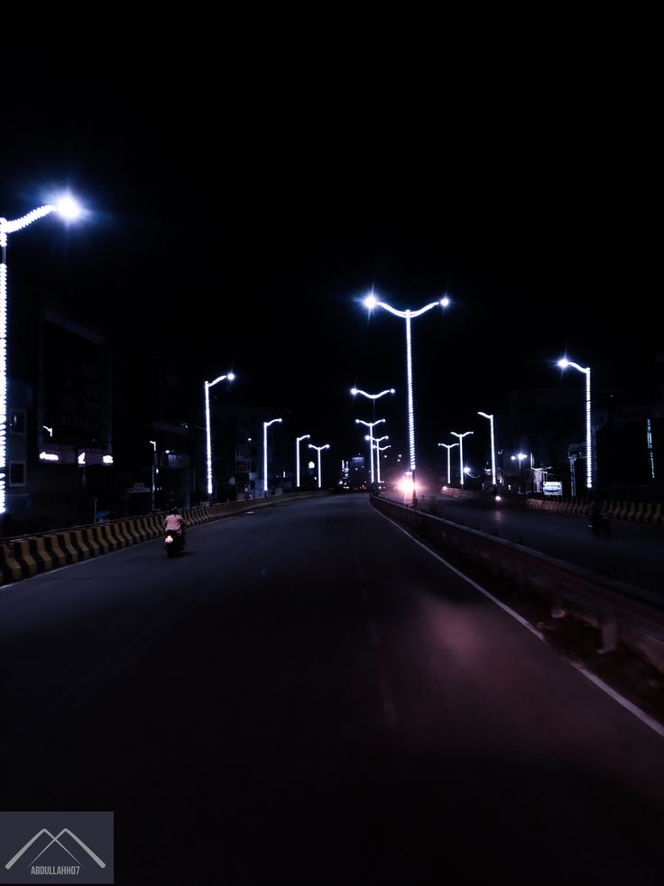 an empty road at night with street lights