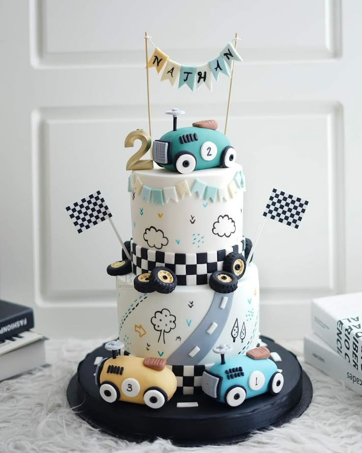 a three tiered cake with cars on it