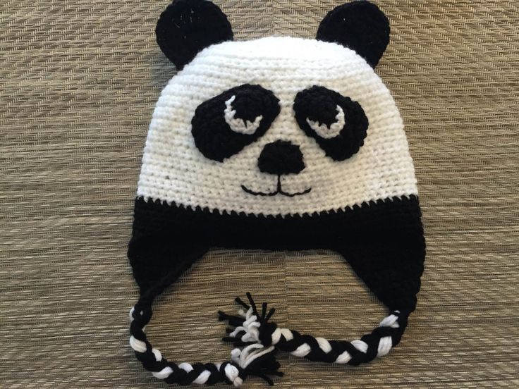 a crocheted panda bear hat with black and white stripes