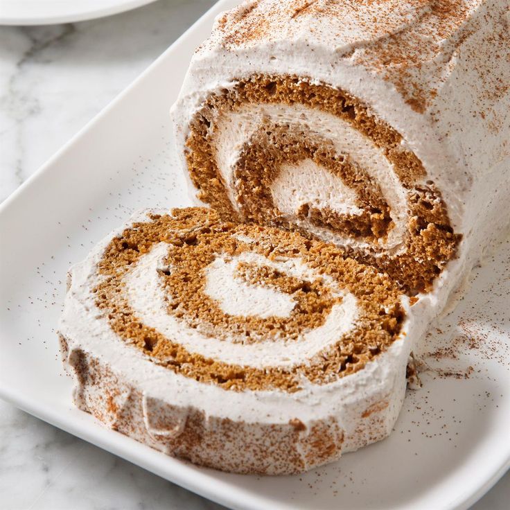 a white plate topped with a cinnamon roll