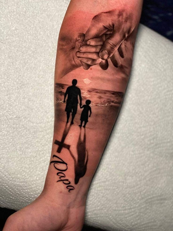 a man and woman holding hands while walking on the beach with their shadow behind them