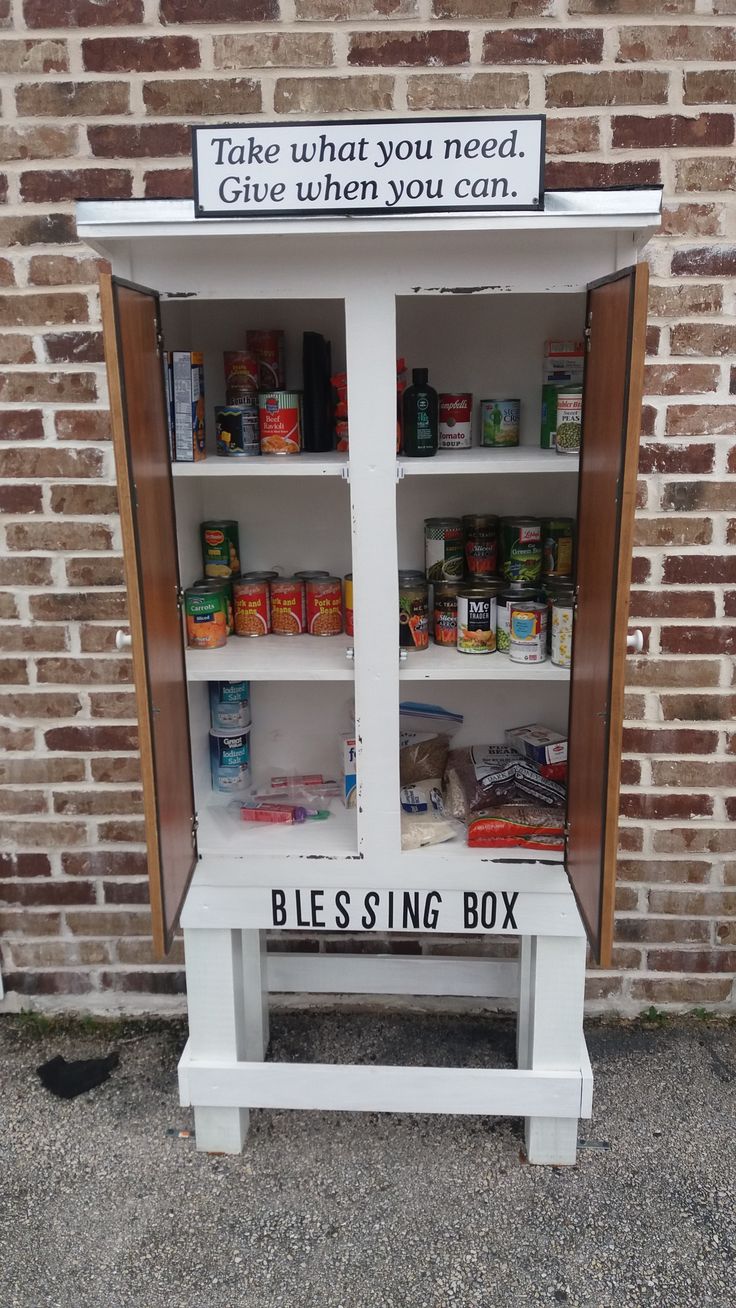 an old fashioned medicine cabinet with canned food in it and the words take what you need give when you can