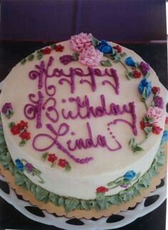 a birthday cake with flowers and writing on it