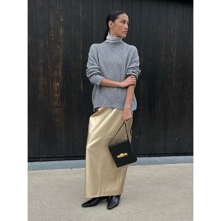 Elevate Your Style with Timeless Elegance Discover the perfect blend of classic charm and modern fashion with our PU Leather High Waist Long Skirt. Designed for the contemporary woman, this skirt is a must-have in your wardrobe for the Autumn and Winter seasons. Whether it's a day at the office, a casual outing, or a special evening event, this versatile skirt promises to elevate your style effortlessly. Exquisite Design and Quality Crafted with meticulous attention to detail, this skirt features a sleek A-line silhouette that flatters your figure while providing a comfortable fit. The eye-catching gold tone adds a touch of luxury and sophistication to your outfit. The ankle-length cut ensures elegance in every step, complemented by a stylish button decoration that enhances its visual appe Chic Full Maxi Skirt, Chic Denim Midi Skirt, Elegant Spring Office Maxi Skirt, Chic Long Pleated Skirt, Chic Workwear Flared Maxi Skirt, Chic Flared Maxi Skirt For Work, Elegant Asymmetrical Maxi Skirt For Fall, Chic Office Flared Maxi Skirt, Chic Flared Maxi Skirt For Office