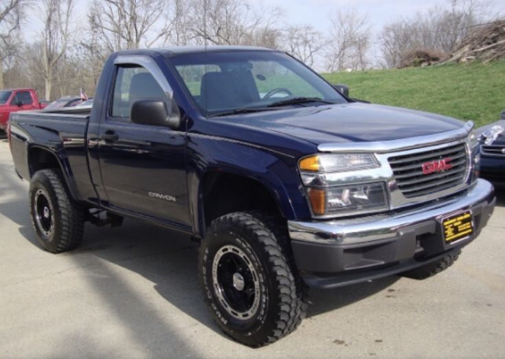 a black truck parked in a parking lot