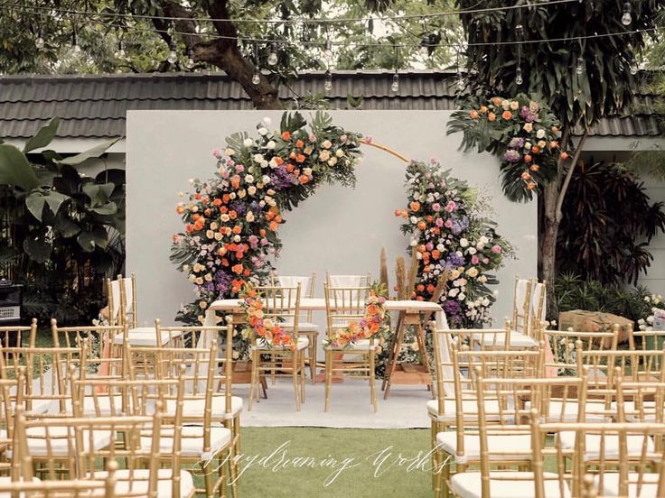 an outdoor wedding setup with floral arrangements and chairs