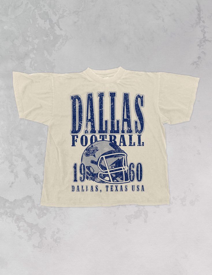 Show the love for your favorite team in this Dallas Football oversized tshirt that is inspired by vintage 90s N F L tshirts!- Features Dallas Football across the top with a football helmet and 1960 with Dallas, Texas USA underneath all in a navy and grey ink- Screen print transfer that is heat pressed onto each tshirt- Tshirt is a super soft vintage wash that gets softer after each wash- Oversized fit- Sizing translation: XS/S - L , S/M - XL , L/XL - 2XL , 2XL/3XL - 3XL * colors may vary slightl College Graphic Tees, Sorority Football Shirts, Vintage Sports Design, Vintage Sports Shirts, Vintage Sports Shirt, Vintage Sports Tees, Tshirt Merch Design, College Tshirt Designs, Vintage Oversized Tshirt