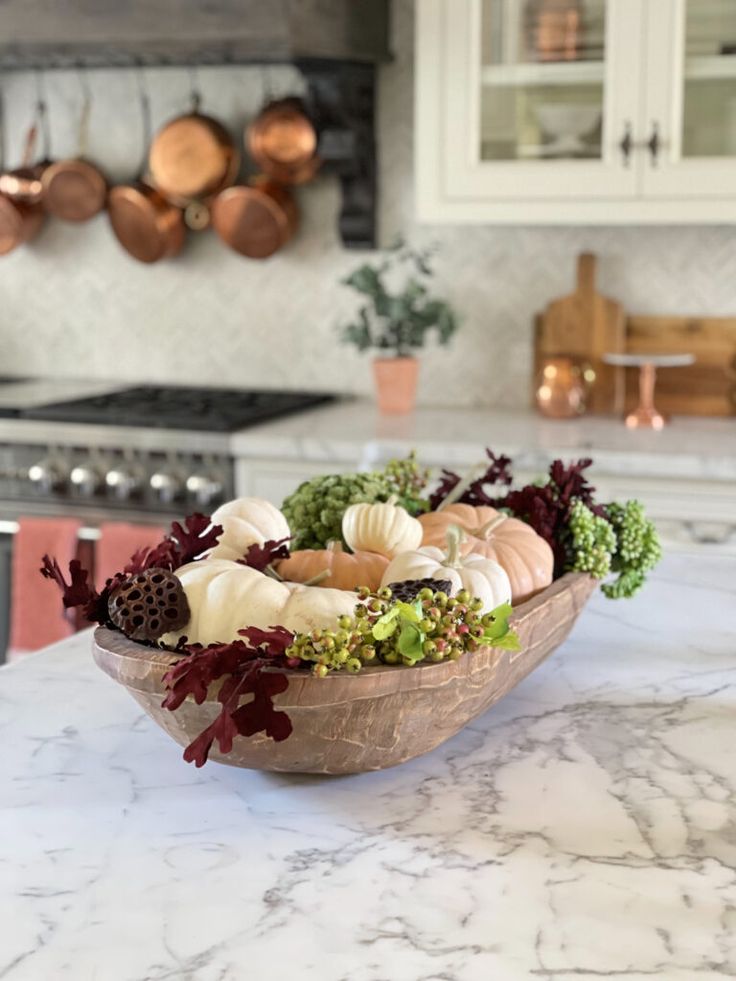 a bowl filled with vegetables sitting on top of a kitchen counter