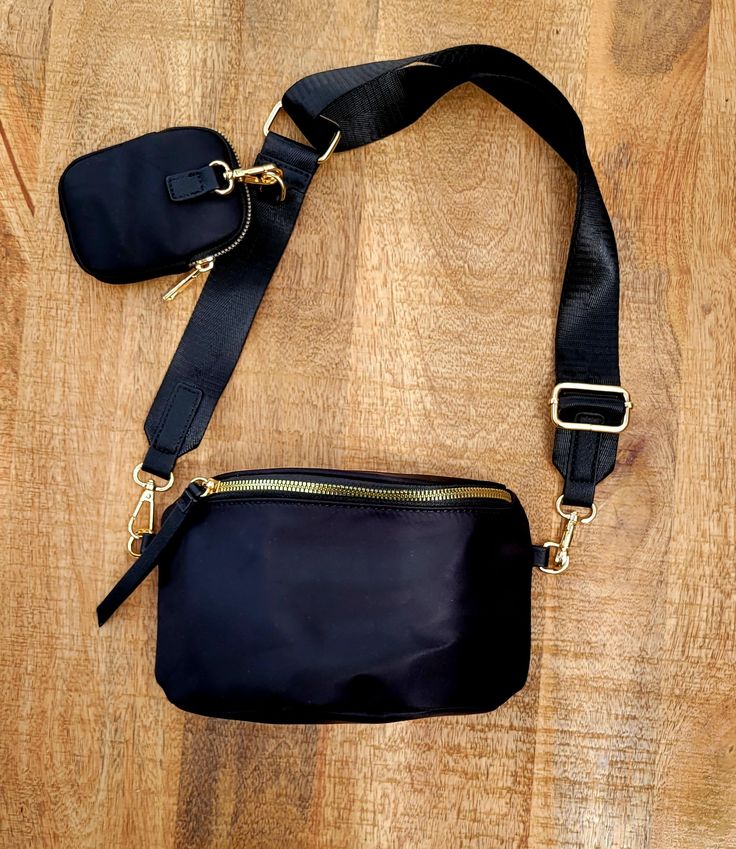 The one that we keep coming back to- this is the Urban Elm's best selling bag. The Britton Bag is a modern take on the traditional fanny pack, and features an adjustable strap that can be used cross body or as a fanny pack. We love this bag, and you will too. Details A modern take on the traditional fanny pack silhouette Composed of premium nylon with gold hardware detailing Sleek leather zipper tassels Includes an adjustable and detachable twill webbing strap for multiple wearing option Wear it Chest Shoulder Bag With Detachable Strap For On-the-go, Versatile Belt Bag With Adjustable Strap, Versatile Shoulder Belt Bag With Adjustable Strap, Daily Use Crossbody Belt Bag With Adjustable Strap, Functional Satchel Belt Bag With Adjustable Strap, Trendy Crossbody Belt Bag With Adjustable Strap, Travel Belt Bag With Adjustable Strap, Trendy Belt Bag With Adjustable Strap, Trendy Shoulder Belt Bag With Adjustable Strap