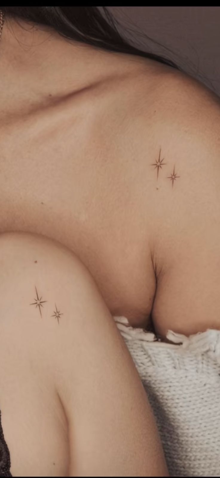 a close up of a person's breast with stars on the back of it