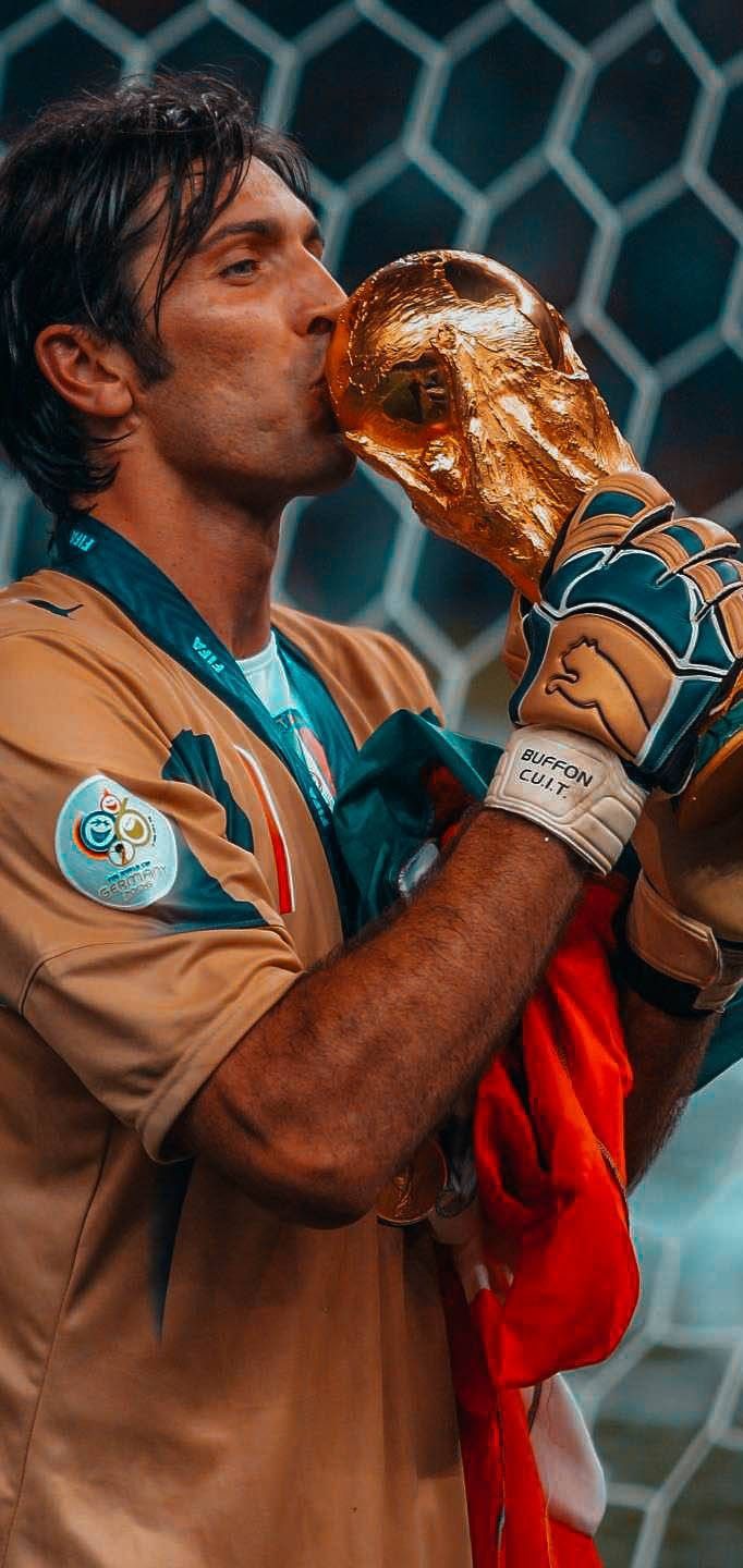 a soccer player drinking from a golden trophy