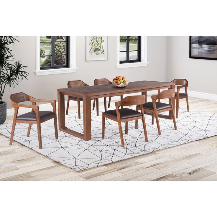 a dining room table with six chairs and a rug on the floor in front of it