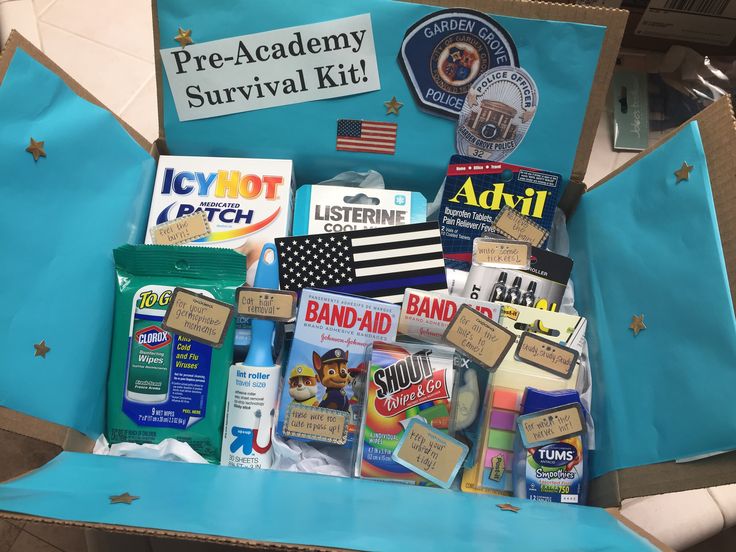 an open cardboard box with various items in it and some stickers on the lid