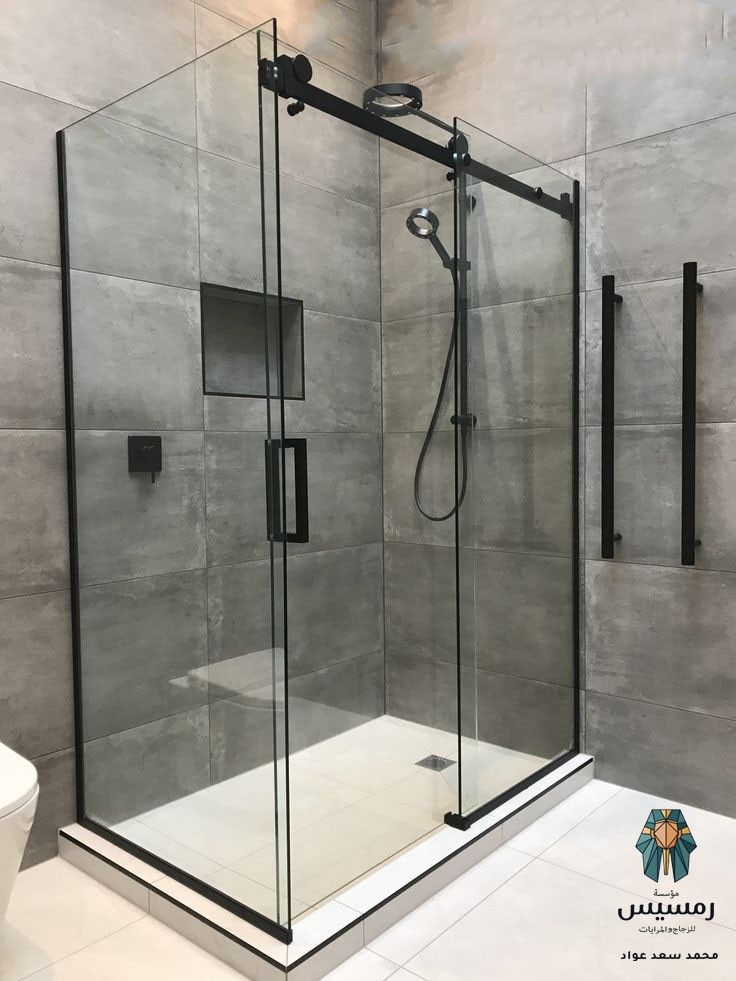 a bathroom with a walk in shower next to a toilet