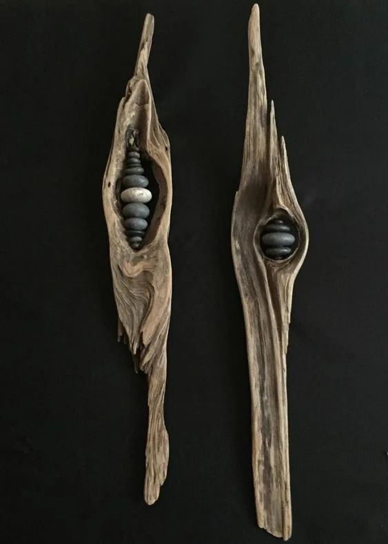 two pieces of wood that have been carved to look like branches with rocks in them