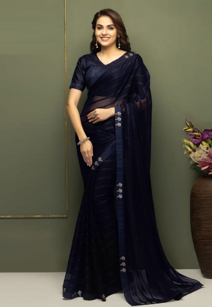 Navy blue chiffon designer saree with blouse SV215 Stylish chiffon sarees with a designer blouse, perfect for a chic appearance on casual occasions. Ideal for those seeking a simple yet elegant look.ish and timeless for years to come. Purchase these sarees exclusively at Kollybollyethnics. Desc:  Color : Navy blue Fabric : chiffon Work : stone  Blouse :Semi stitch Wash Care : Dry clean Sleeve Style : Half Sleeve Long Sleeves : Done only in Custom Stitch Sleeves Lining : Done only in Custom Stitch Bust Size : 32 to 42 Inches Occasion : Festival   Christmas   Eid   Ceremonial   Pongal   Lohri   Gudi Padwa   Onam   Ugadi   VaisakhiFancy saree chiffon saree light weight saree designer saree. With Express Free Shipping and Custom Stitching, Buy Indian Wedding Party Wear Saree Navy blue chi Navy Blue Saree Party Wear, Elegant Sheer Saree For Festive Occasions, Elegant Festive Sheer Saree, Elegant Blue Chanderi Pre-draped Saree, Blue Blouse With Sheer Dupatta, Elegant Chiffon Pre-draped Saree For Festivals, Elegant Pre-draped Chiffon Saree, Blue Georgette Pre-draped Saree With Self Design, Anarkali Art Silk Saree For Evening